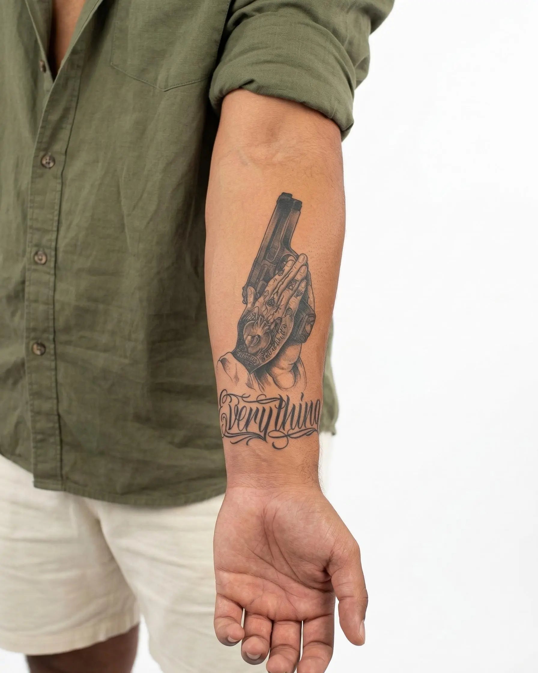 INKON Praying Hands & Pistol semi-permanent tattoo applied on a man – 4 x 7 in (10x17cm) design, realistic ink look, lasts 10 days