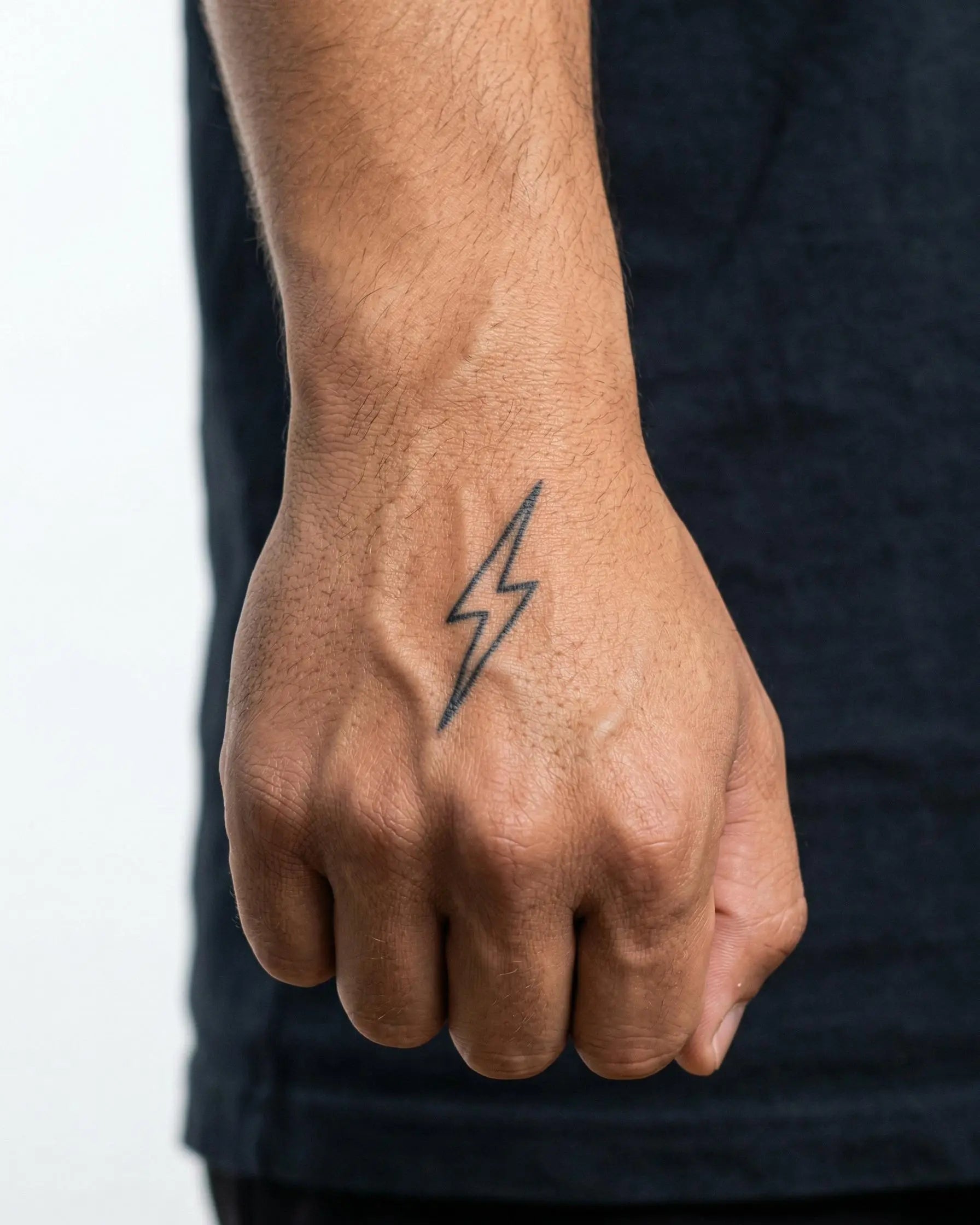 INKON Thin Lightning Bolt semi-permanent tattoo applied on a man – 2 x 2 in (5x5cm) design, realistic ink look, lasts 10 days