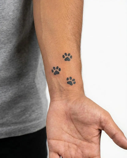 INKON Paw Print Trail semi-permanent tattoo applied on a man – 2 x 2 in (5x5cm) design, realistic ink look, lasts 10 days